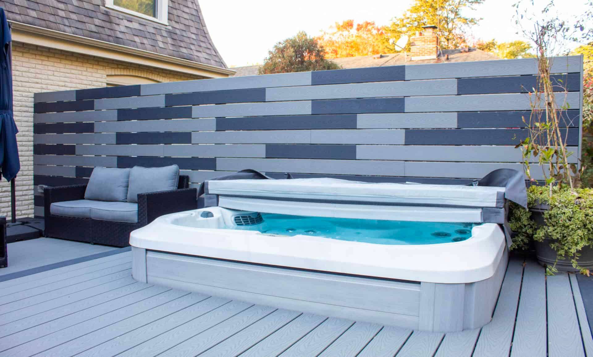 Composite deck with an open swim spa and railing at a suburban home