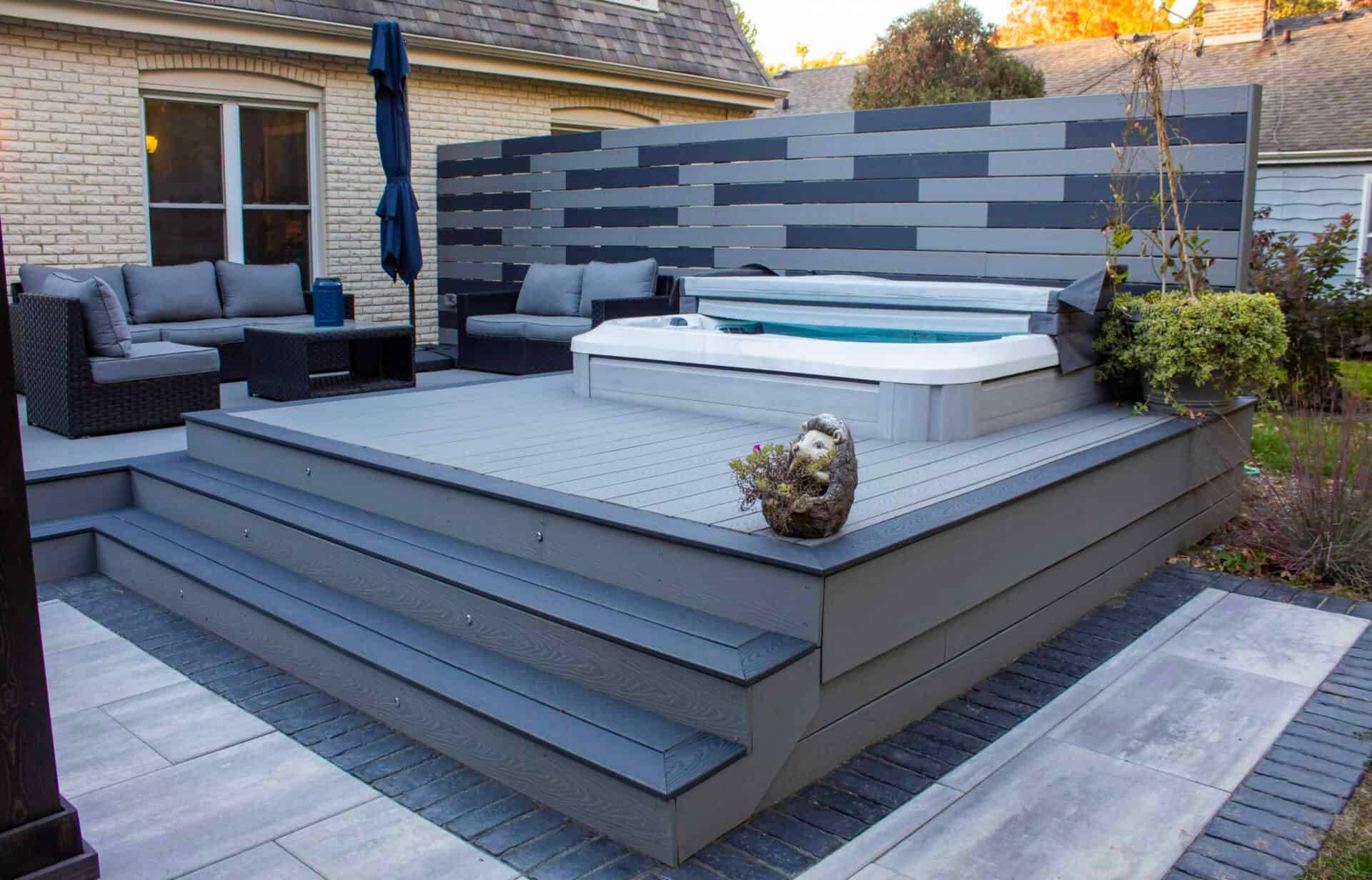 Wide view of a composite deck with an open swim spa and railing