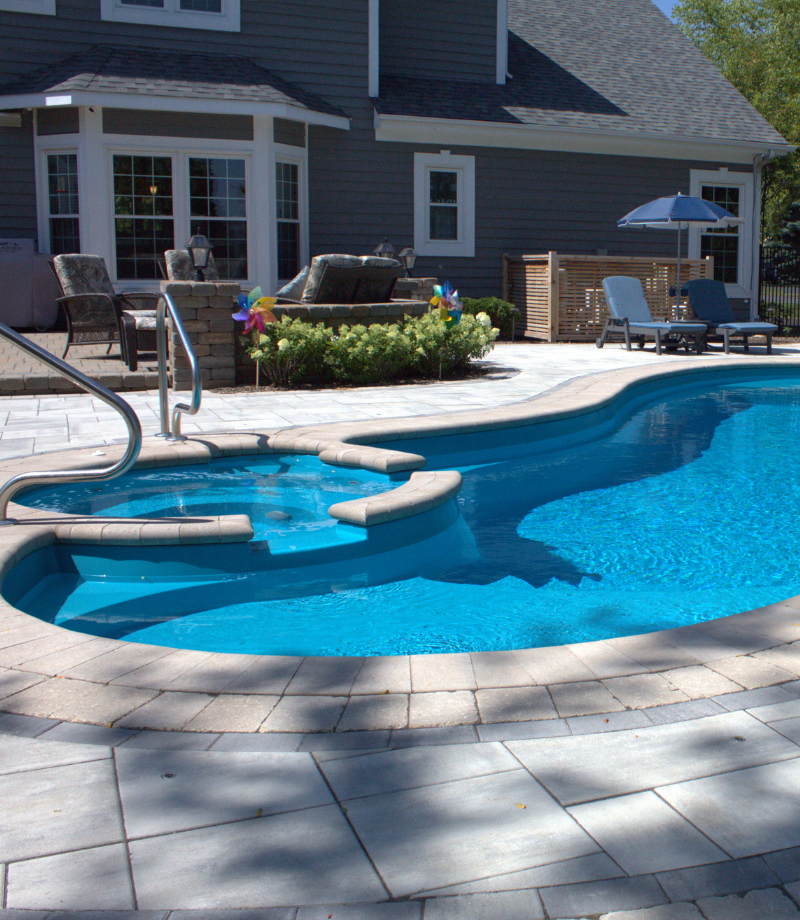 Curved pool edge with broad steps and surrounding paving