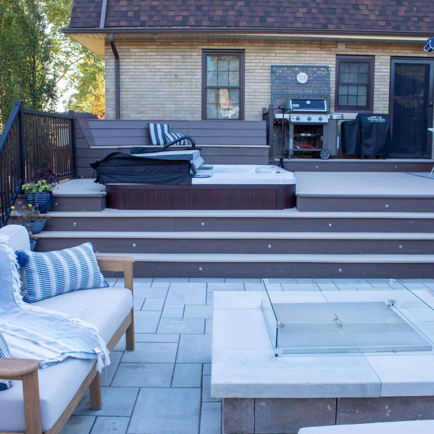Multi-level deck with a hot tub, paver patio, gas fire pit and outdoor kitchen